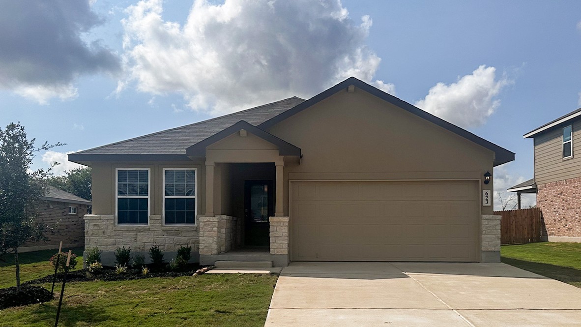 One story home with covered porch, brick front exterior and two car garage.