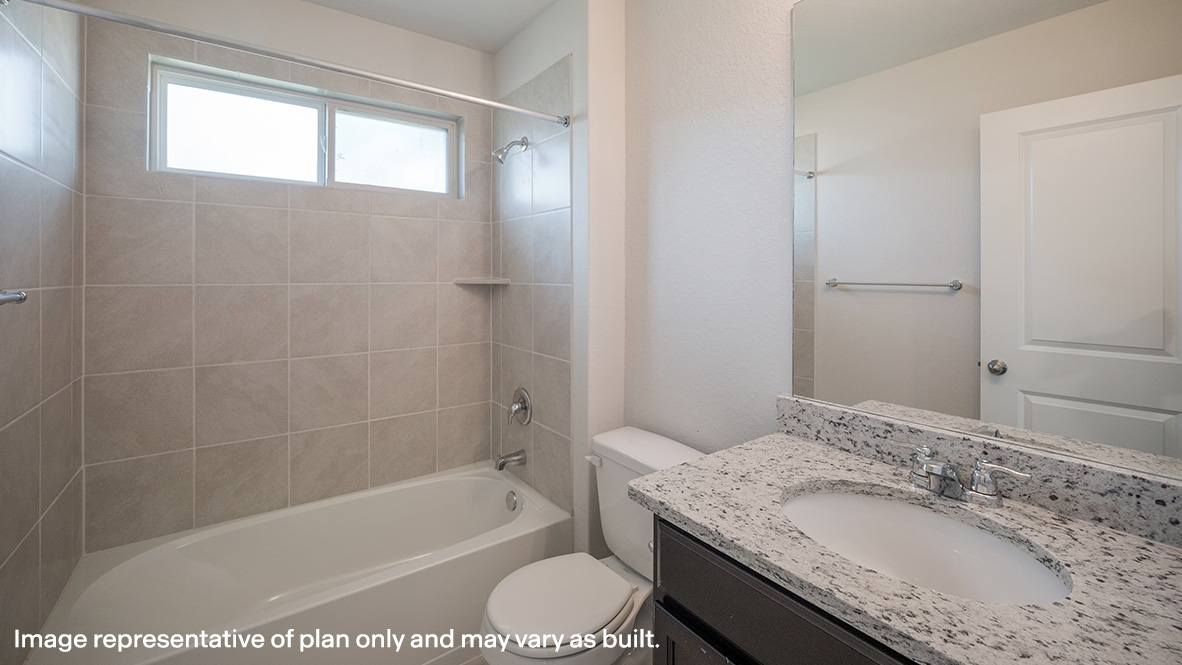 Second full bathroom with combined bathtub and shower, toilet and hard surface flooring.