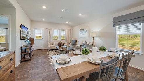 Floresville Links at River Bend New Construction Homes Open floor concept with large living space and white couch