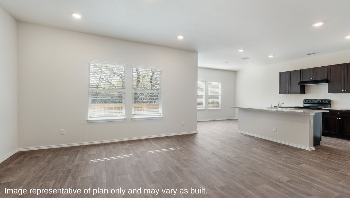 DR Horton Von Ormy Preserve at Medina the emma floor plan 1700 square feet open concept living room with hard surface flooring flowing to kitchen and dining area