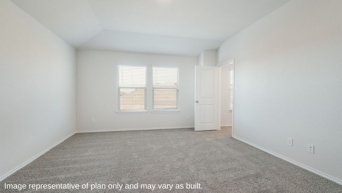 DR Horton Von Ormy Preserve at Medina the emma floor plan 1700 square feet main bedroom suite with carpet flooring large windows and doorway leading to ensuite bathroom