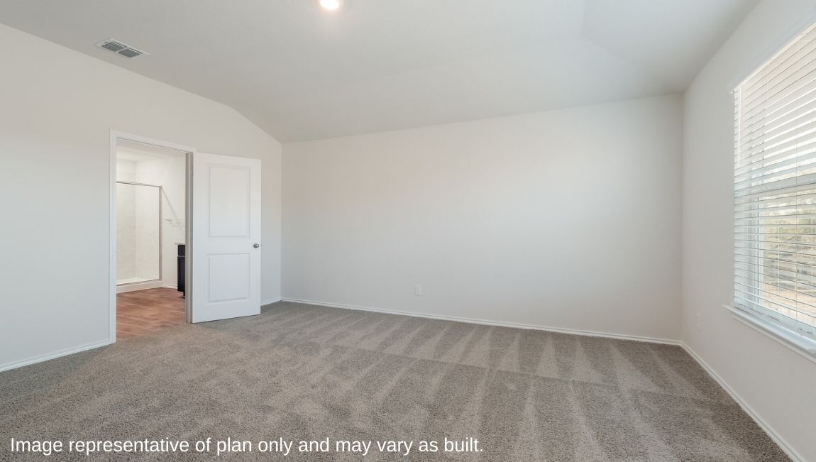 DR Horton Von Ormy Preserve at Medina the emma floor plan 1700 square feet main bedroom suite with carpet flooring large windows and doorway leading to ensuite bathroom