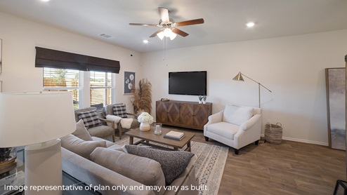 DR Horton Von Ormy Preserve at Medina the nicole floor plan 2473 square feet 2 story 2 car garage living room with couch coffee table and entertainment center console