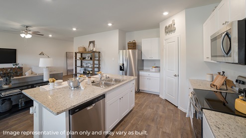 DR Horton Von Ormy Preserve at Medina the nicole floor plan 2473 square feet kitchen with corner pantry white cabinetry granite countertops kitchen island and bar stools