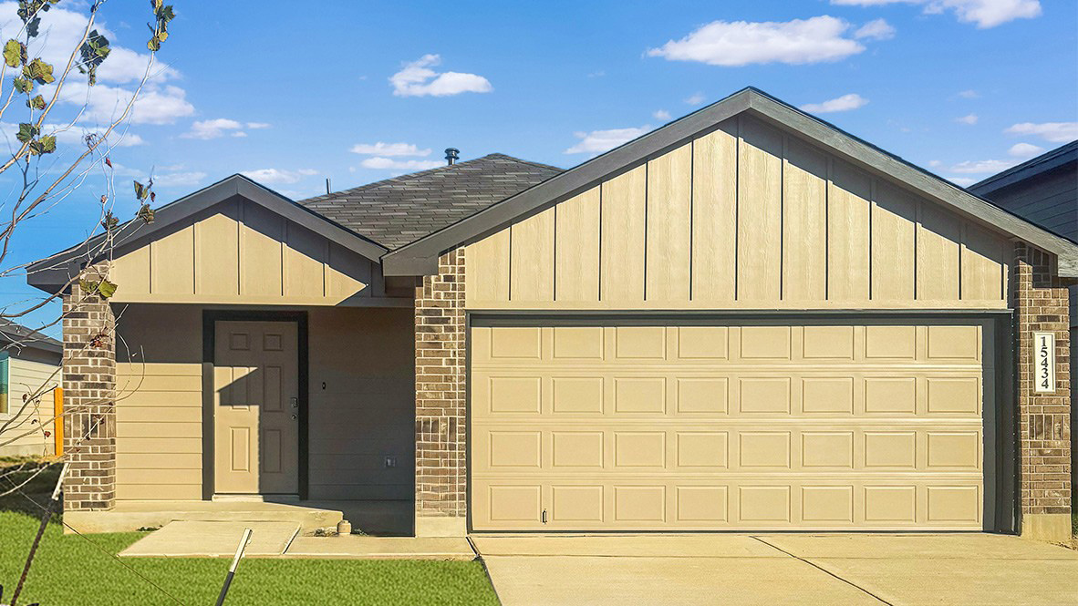 Front of home with two car garage.