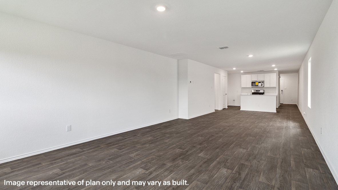 Spacious living room with view into dining and kitchen areas, and outside access at Preserve at Medina