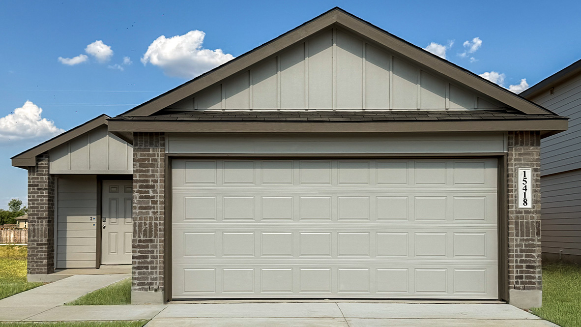 Front exterior of home with two car garage.