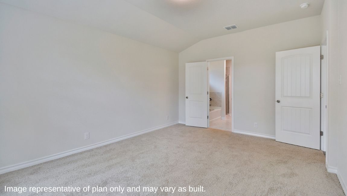Primary bedroom with neutral walls, carpet, and natural lighting.