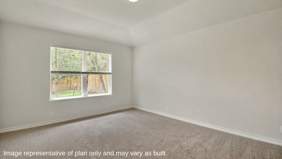 Primary bedroom with large windows and neutral walls.