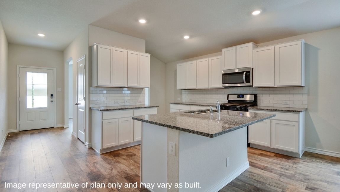 Kitchen showcasing new stainless steel appliances, cabinets, and countertops.
