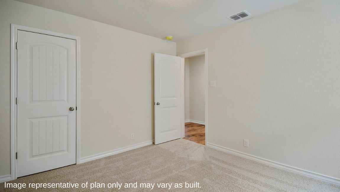 Bedroom with neutral walls, closet space, and natural lighting.