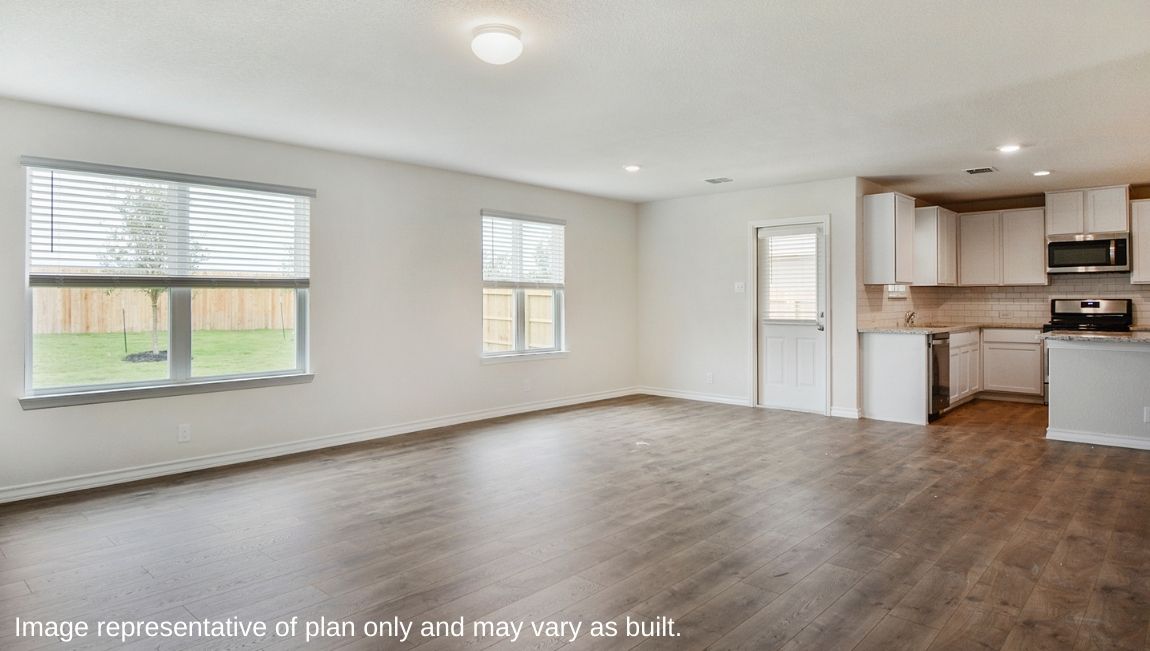 Open concept living space with natural light and a back door.
