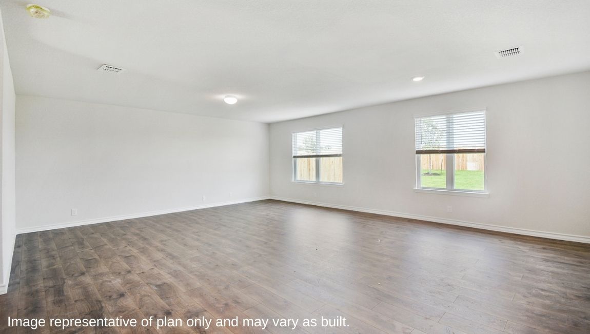 Bright living room with large windows and neutral walls.