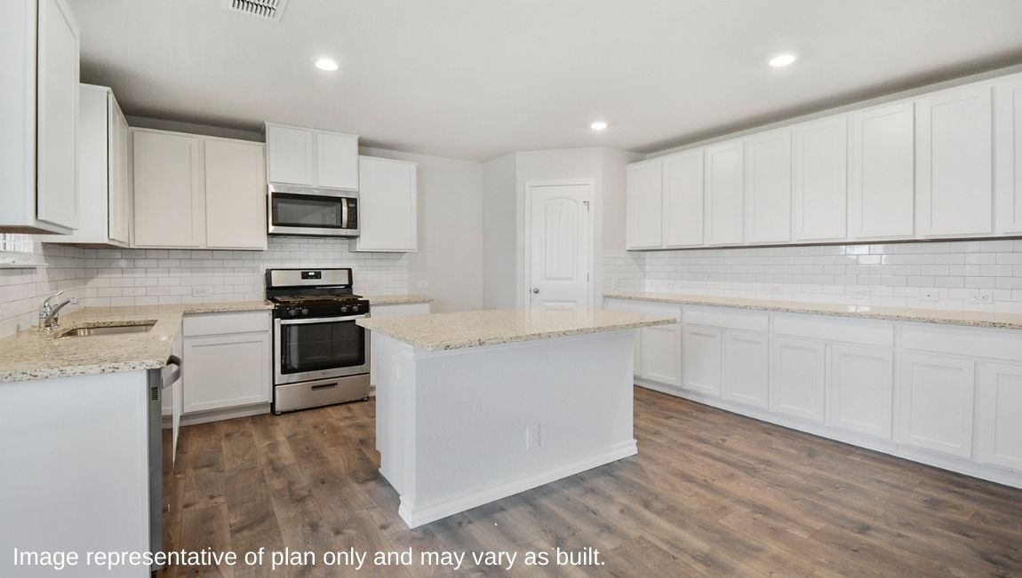 Kitchen featuring brand new stainless steel appliances, cabinets, and a large island.