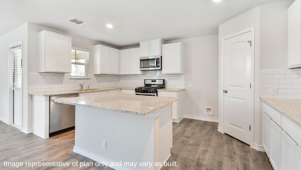 Kitchen showcasing new stainless steel appliances, cabinets, and countertops.