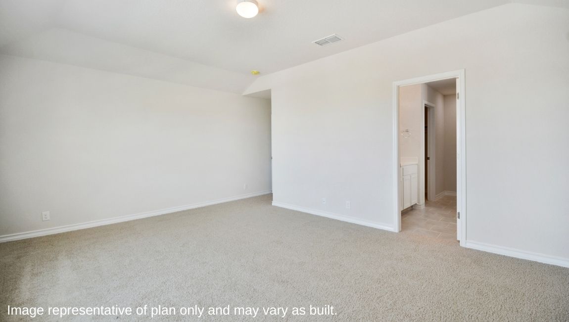 Primary bedroom with neutral walls, carpet, and natural lighting.