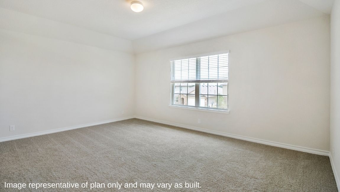 Primary bedroom with large windows and neutral walls.