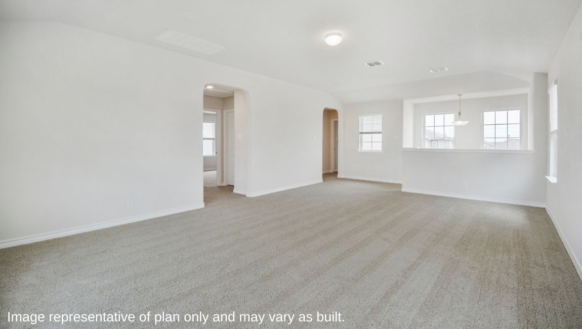 Large loft area with carpet and natural light.