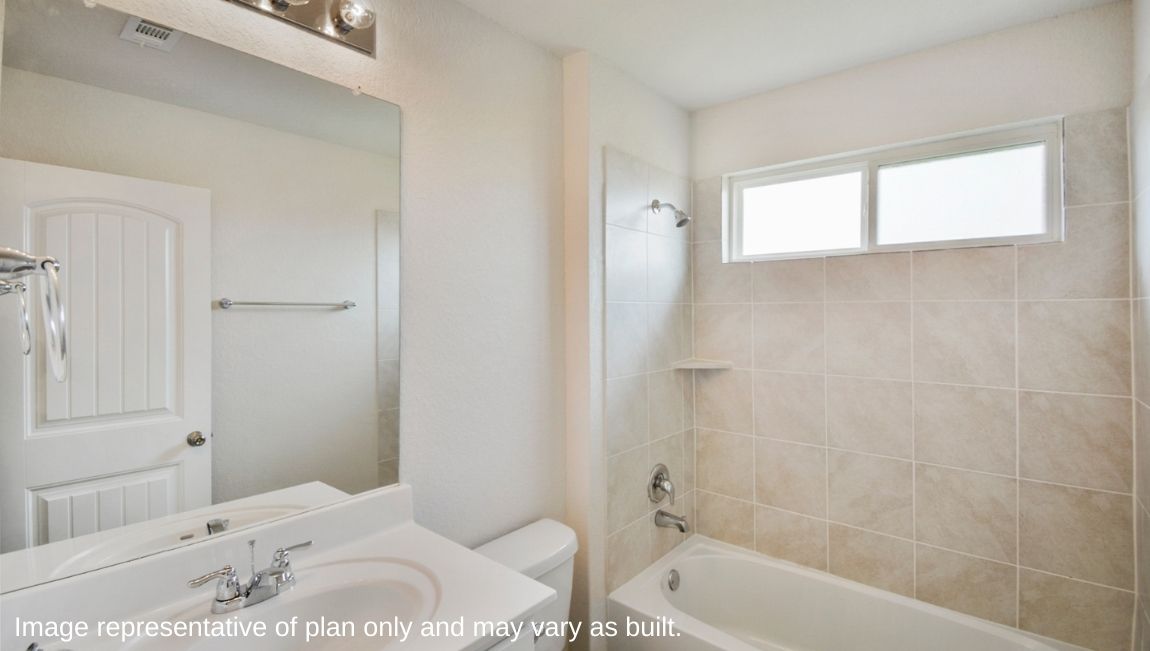 Bathroom featuring a sink, toilet, and shower tub.