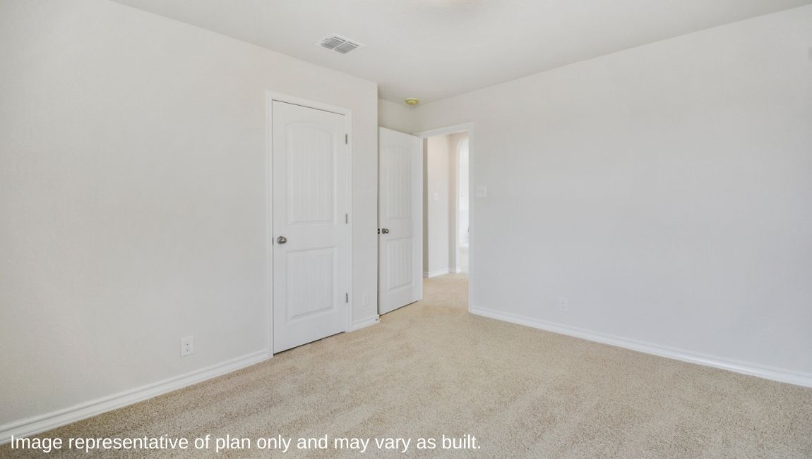 Bedroom with neutral walls, closet space, and natural lighting.