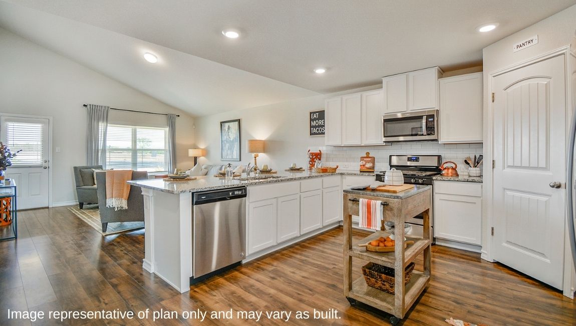 Spacious kitchen with brand new stainless steel appliances connecting to the living area.