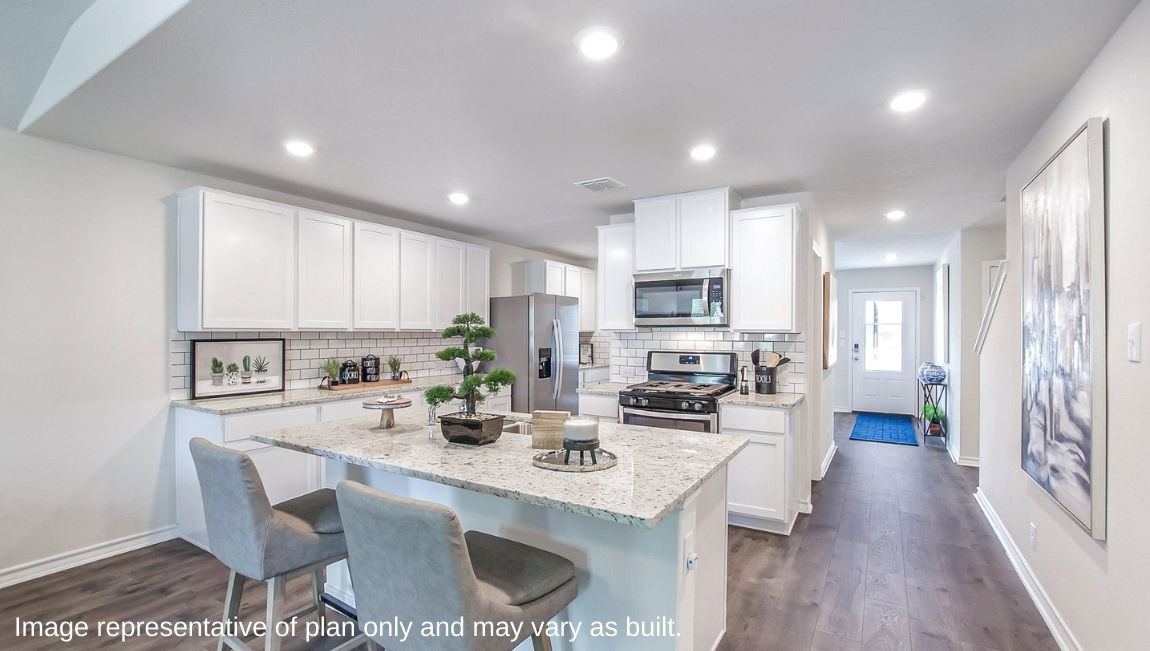Kitchen showcasing new stainless steel appliances, cabinets, and countertops.