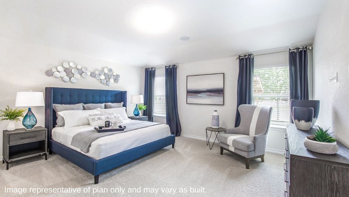 Primary bedroom with neutral walls, carpet, and natural lighting.