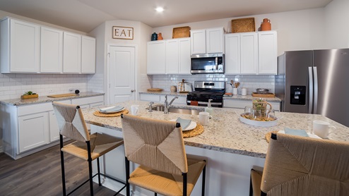 DR Horton Converse Avenida 5318 la rambla model the bryant floor plan 1703 square feet kitchen with white cabinets spacious kitchen island and stainless steel appliances