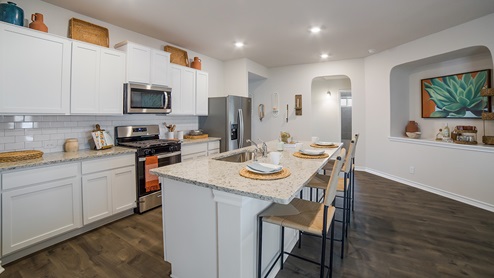 DR Horton Converse Avenida 5318 la rambla model the bryant floor plan 1703 square feet kitchen with white cabinets spacious kitchen island and stainless steel appliances