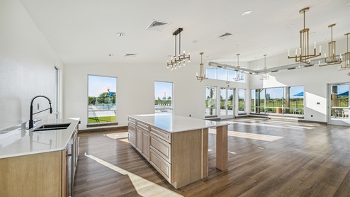 DR Horton Converse Avenida amenity center indoor with hard surface flooring, kitchen and natural lighting