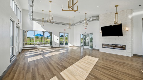 DR Horton Converse Avenida amenity center indoor with hard surface flooring, kitchen and natural lighting