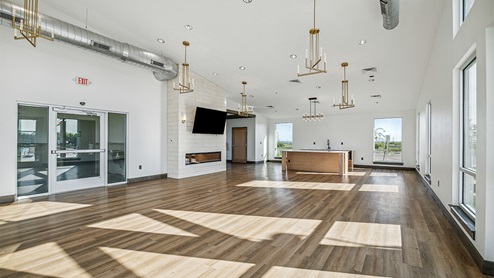 DR Horton Converse Avenida amenity center indoor with hard surface flooring, kitchen and natural lighting