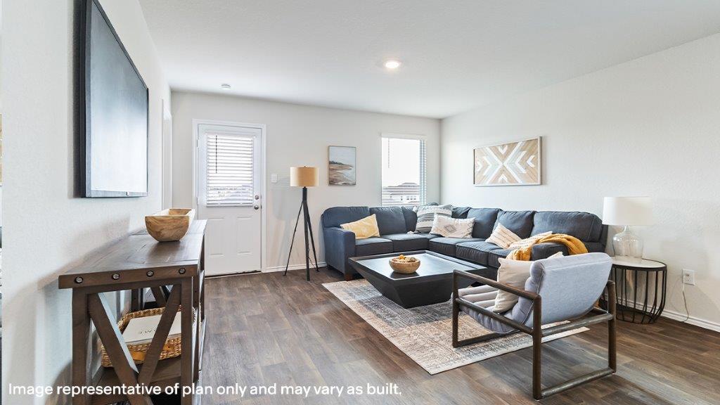 Living room with windows and a door for outside access.