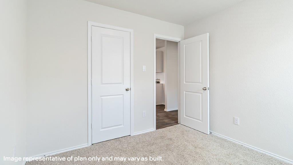 Bedroom with a window and carpeted floors.