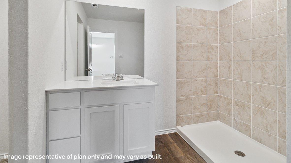 Bathroom with a single vanity sink and a walk in shower.