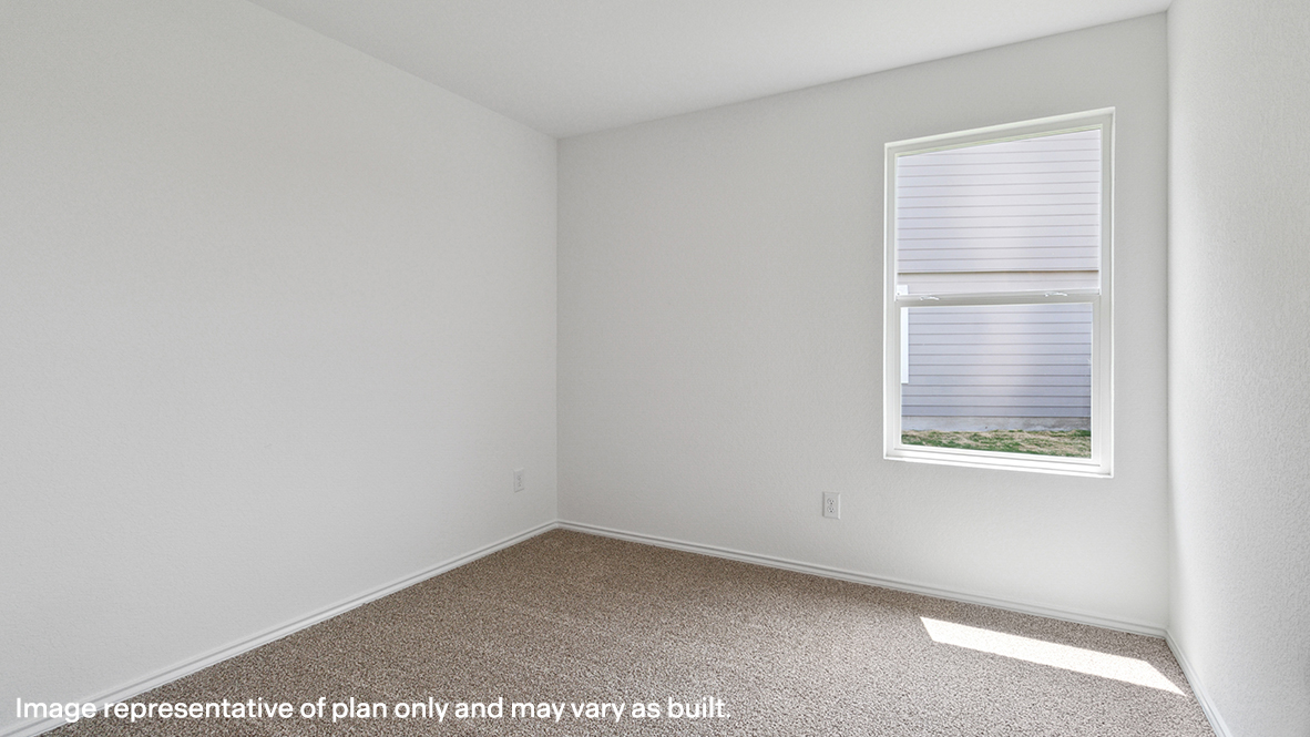 Bedroom with carpeted floors and a window.