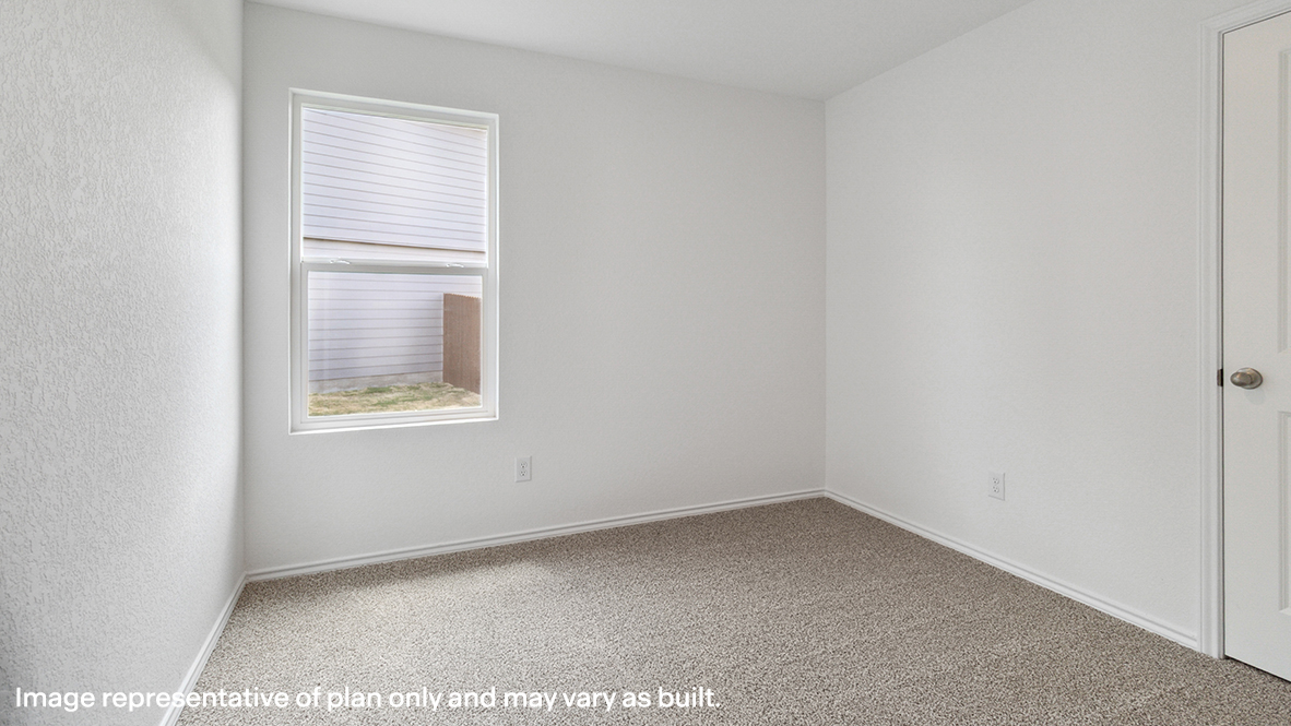 Bedroom with carpeted floors and a window.