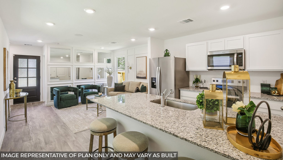 Spacious living room with view into dining and kitchen areas, and outside access at Sonora