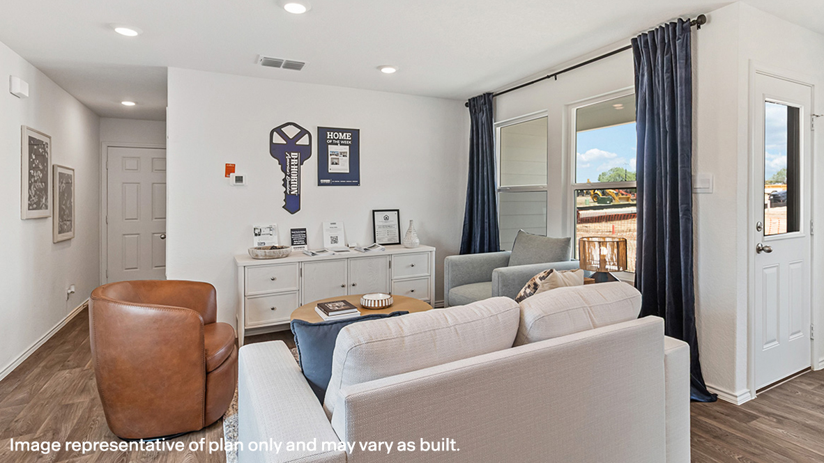 Living room looking to dining and kitchen areas in this new home features natural light, with fresh open concept flow