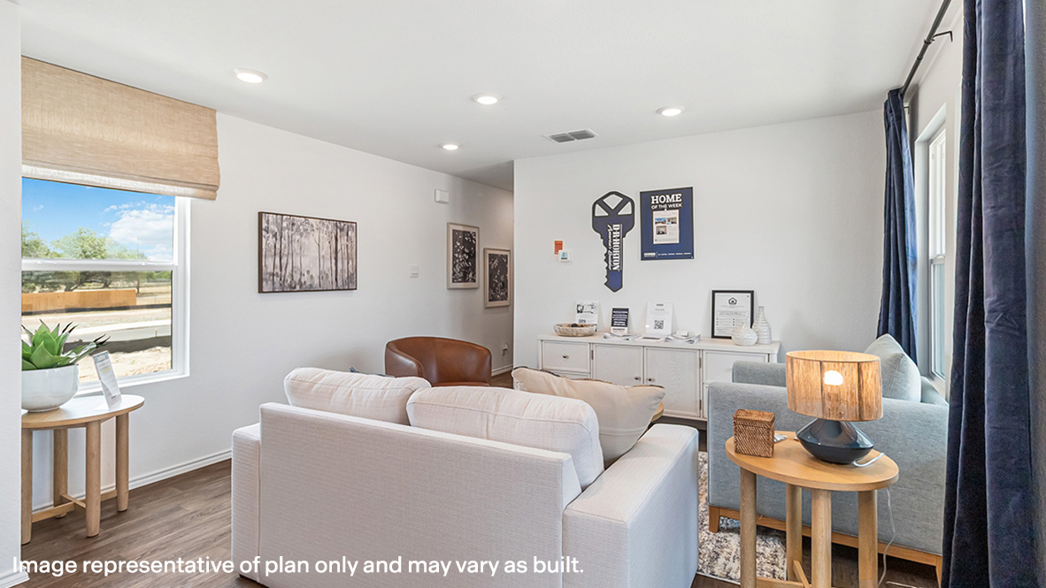 Living room looking to dining and kitchen areas in this new home features natural light, with fresh open concept flow