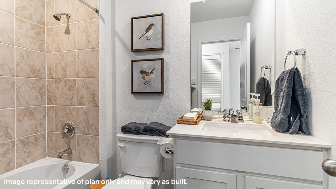 Secondary bathroom adds style and comfort with a combination shower-tub, cabinet storage, vanity, mirror at Sonora