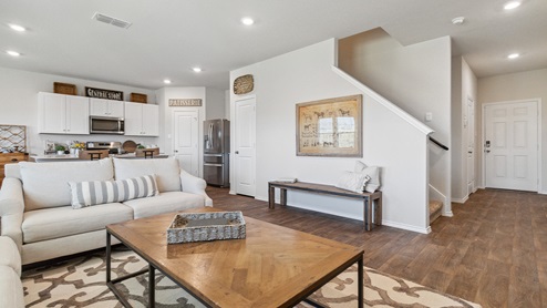Hacienda Model Open-concept living area with hard surface flooring and windows providing plenty of natural light.