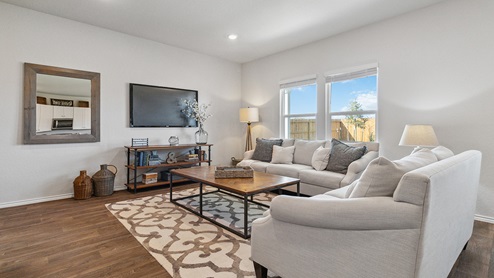 Hacienda Model Open-concept living area with hard surface flooring and windows providing plenty of natural light.