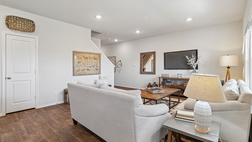 Hacienda Model Open-concept living area with hard surface flooring and windows providing plenty of natural light.