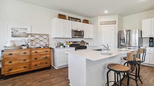 Hacienda Model Spacious, open-concept kitchen with island, shaker style cabinets and granite or quartz countertops.