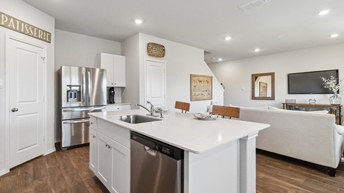 Hacienda Model Spacious kitchen with stainless steel appliances and hard surface flooring.