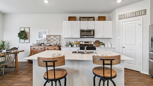 Hacienda Model Spacious kitchen with stainless steel appliances and hard surface flooring.