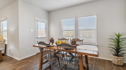 Hacienda Model Open-concept dining area overlooking spacious kitchen with hard surface flooring.