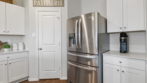 Hacienda Model Spacious kitchen with stainless steel appliances and hard surface flooring.