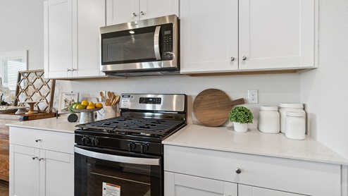 Hacienda Model Spacious, open-concept kitchen with island, shaker style cabinets and granite or quartz countertops.